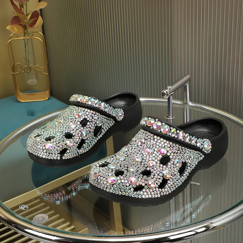 Black women's platform sandals with rhinestone decoration and hole shoe design on an EVA sole.