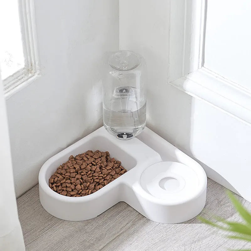 White plastic cat water fountain with filter on a floor next to a cat.