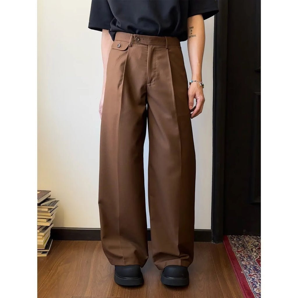 Men's brown straight-leg casual trousers with a loose wide-leg cut on a neutral background.