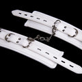 White PU sponge bondage set showing handcuffs, foot cuffs and neck scarf for restraint play