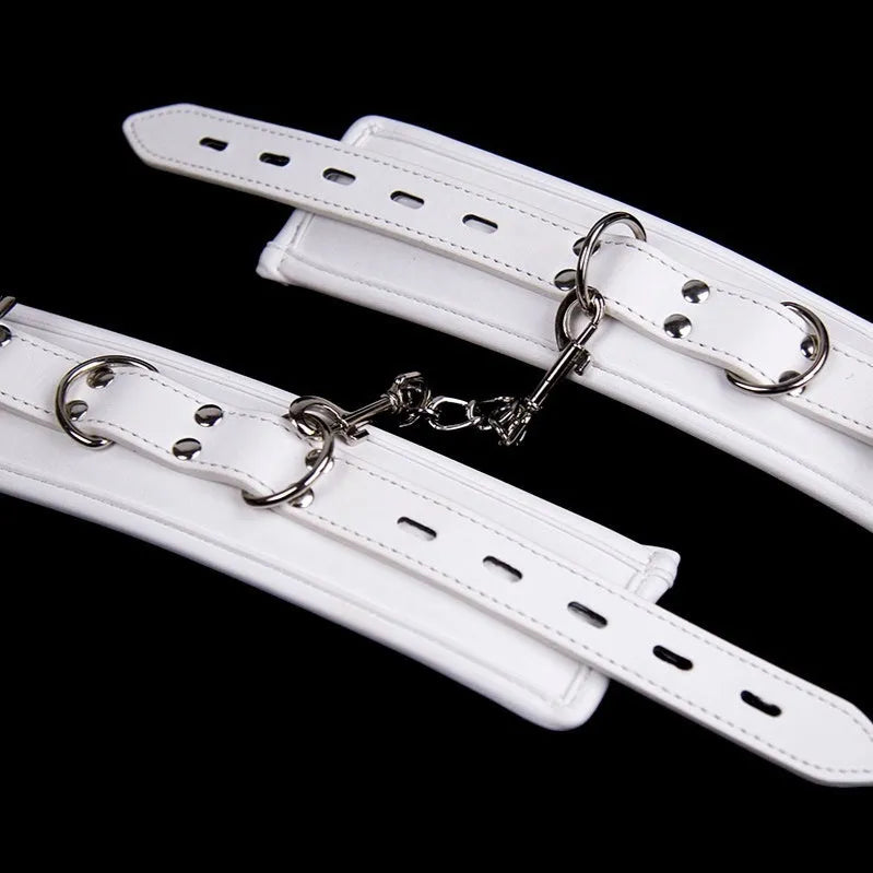 White PU sponge bondage set showing handcuffs, foot cuffs and neck scarf for restraint play