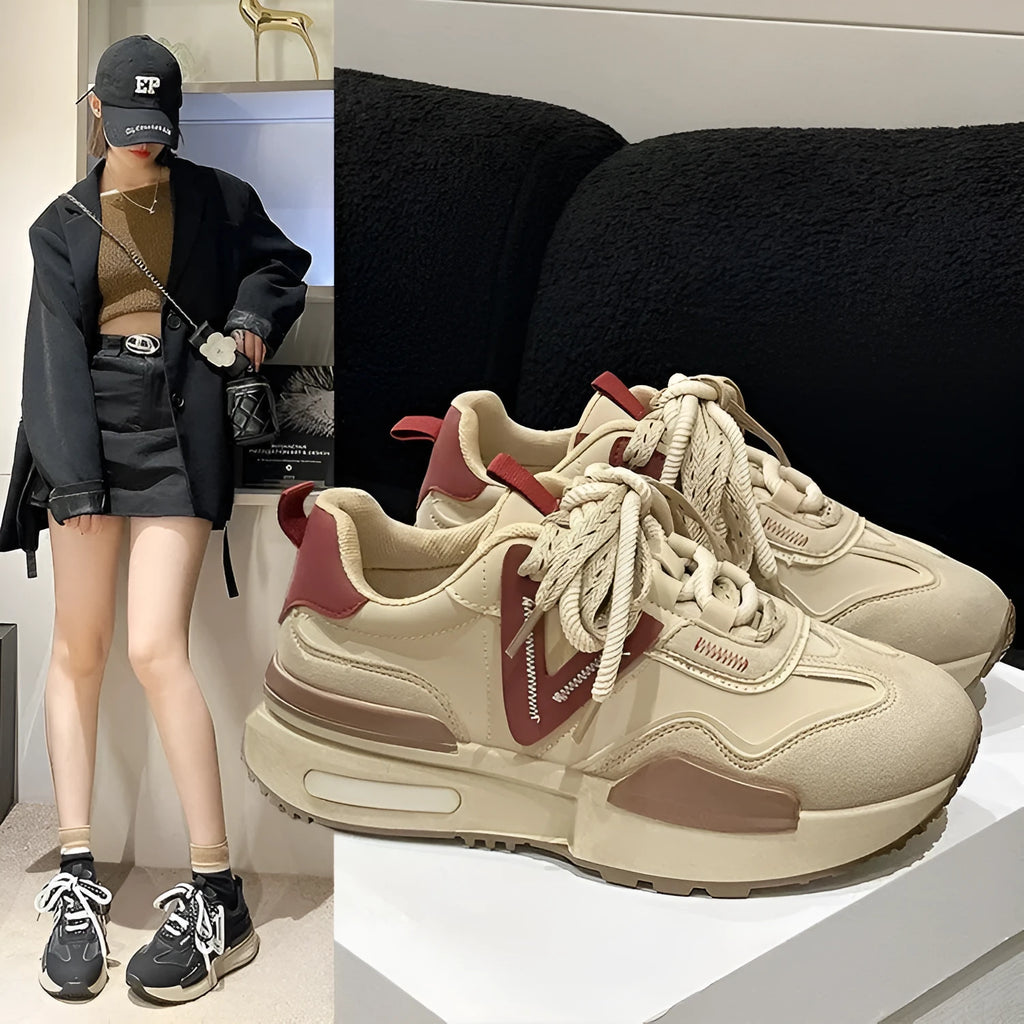Women's black retro platform sports shoes with round toe and white rubber sole on a plain background.