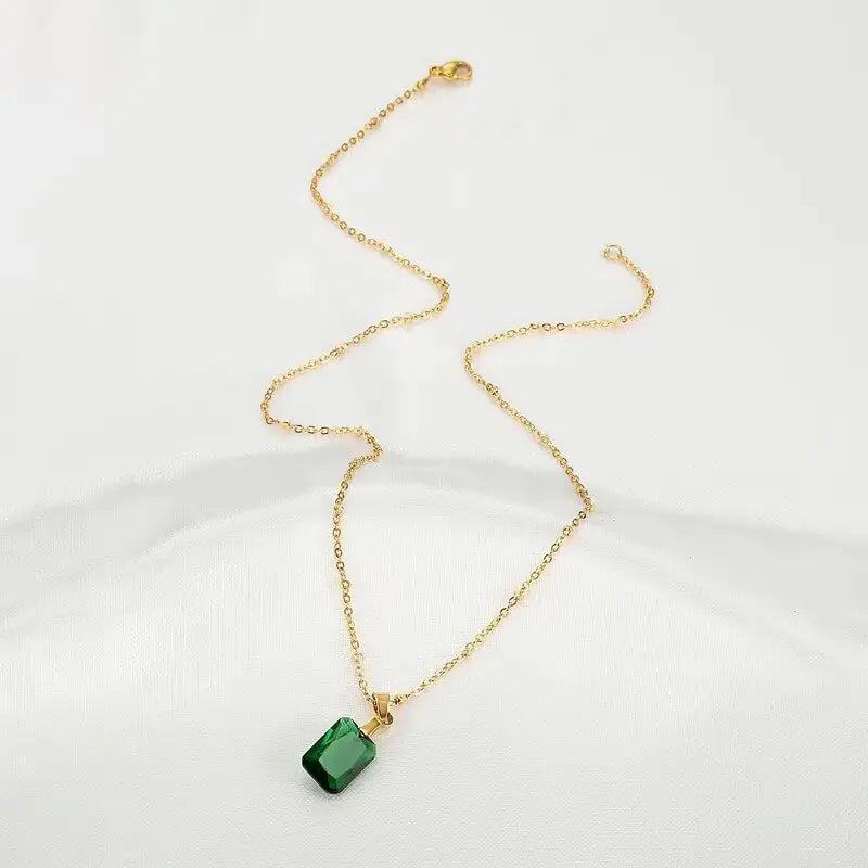 Copper rectangular geometric pendant necklace on an O-ring chain in a retro green colour.