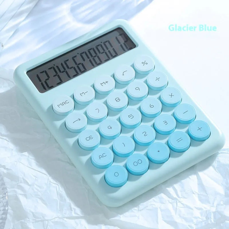 Gradient colour desk calculator in violet, cherry blossom pink, glacier blue, and mint green on a white desk.