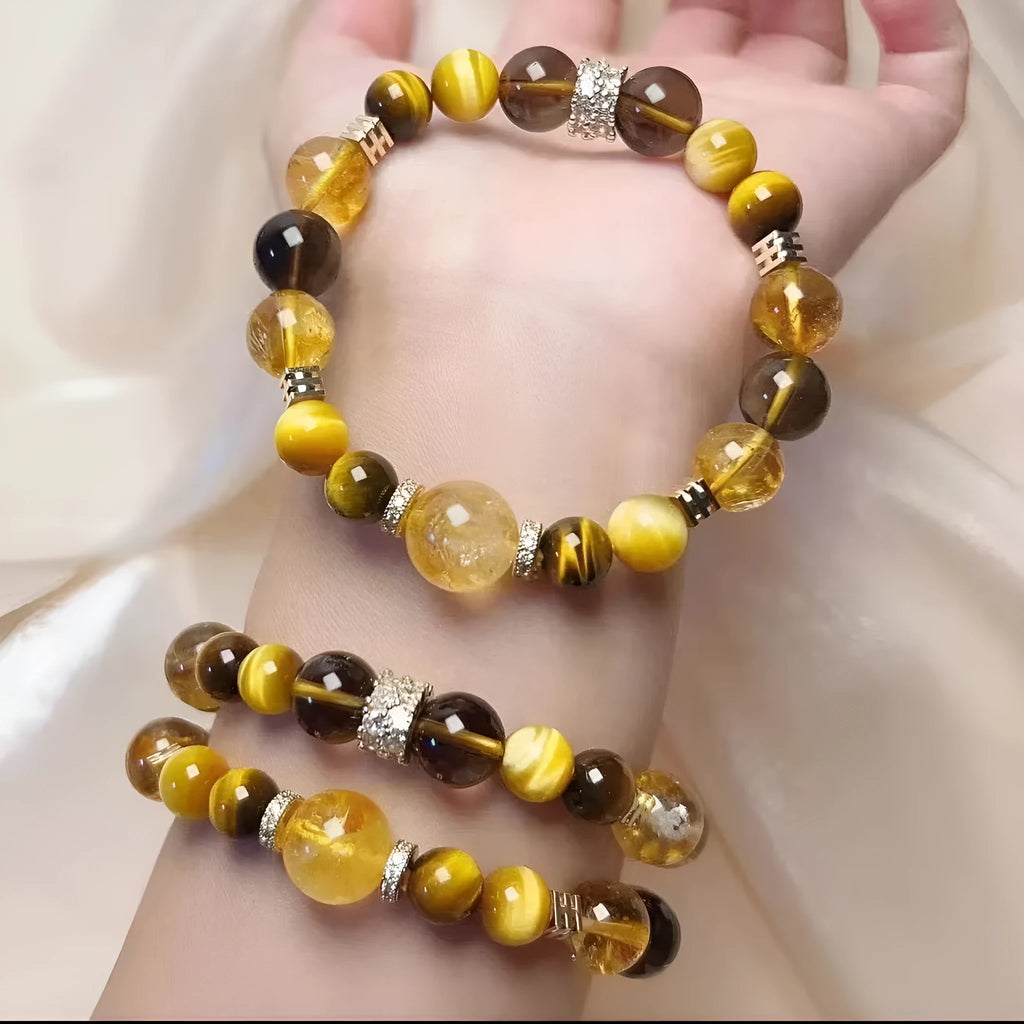 Close-up of a yellow artificial crystal beaded bracelet with 10mm Jinba beads on a wrist.