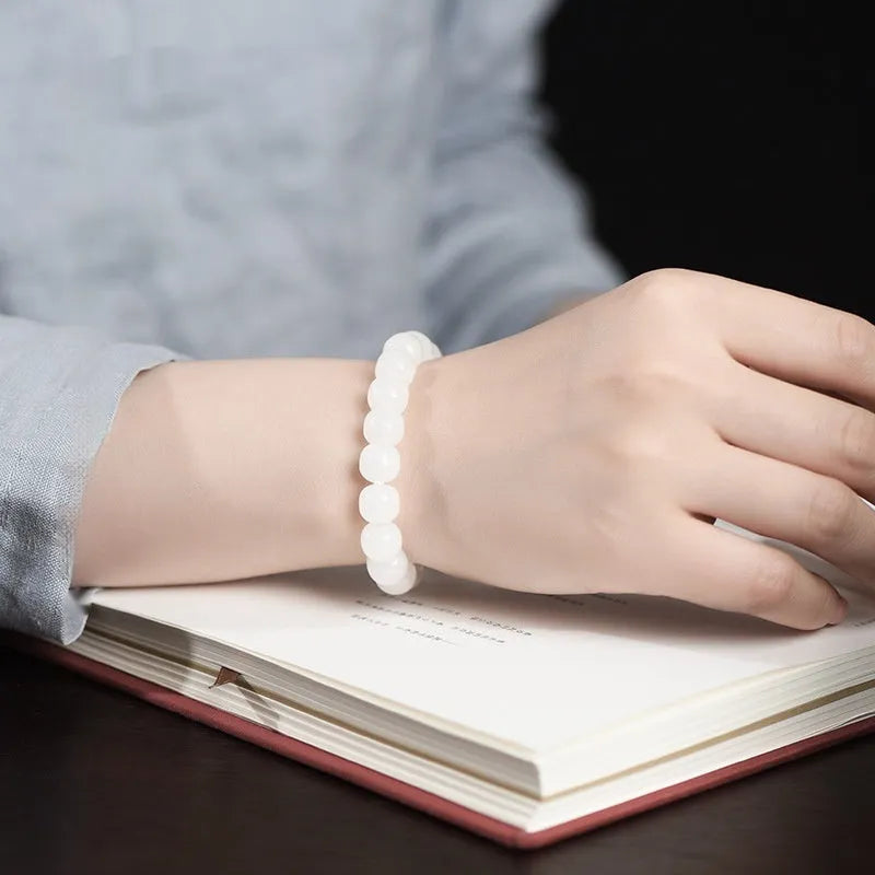 White Hetian jade barrel bead bracelet showing smooth polished beads on wrist