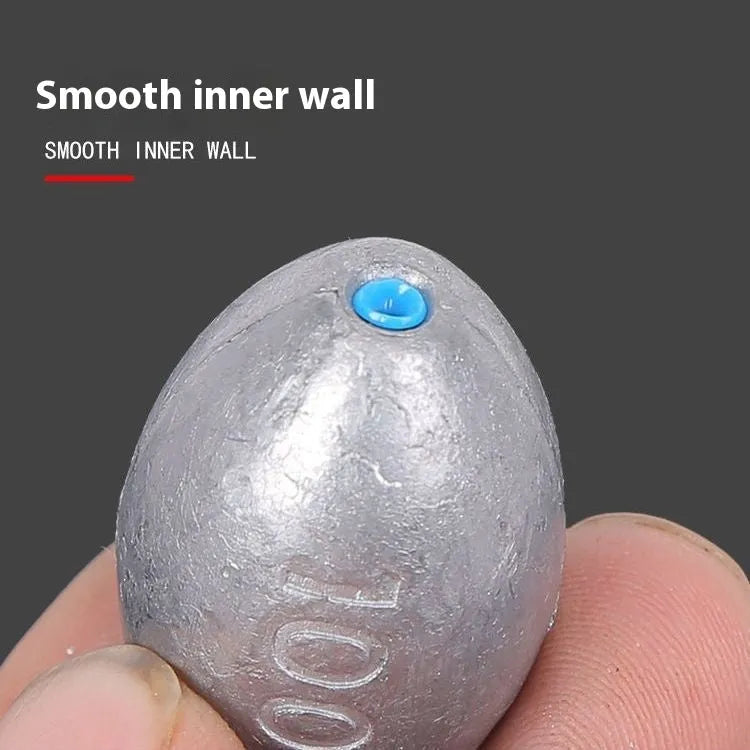 Sea fishing olive lead sinker with plastic core, rugby shape, and textured scale surface