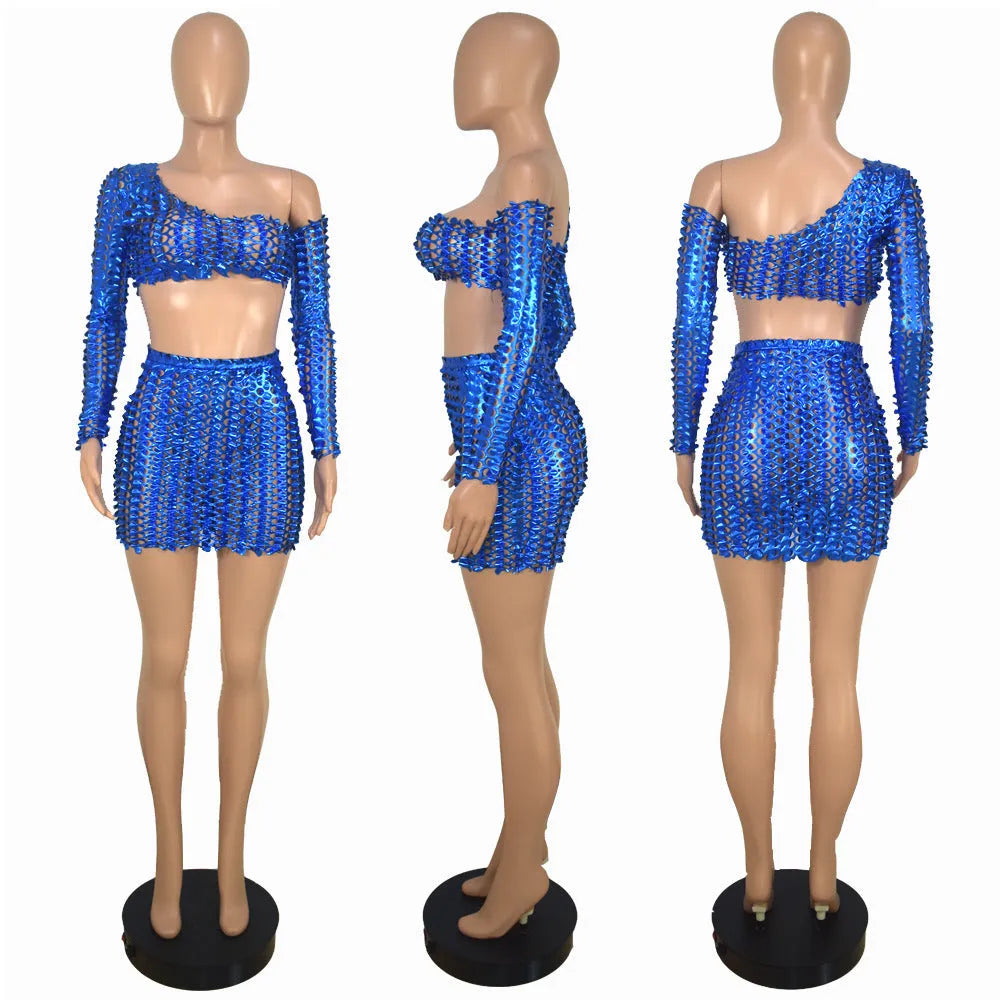 Women's black hollow-out net detail two-piece dress set with sleeveless top and short skirt.