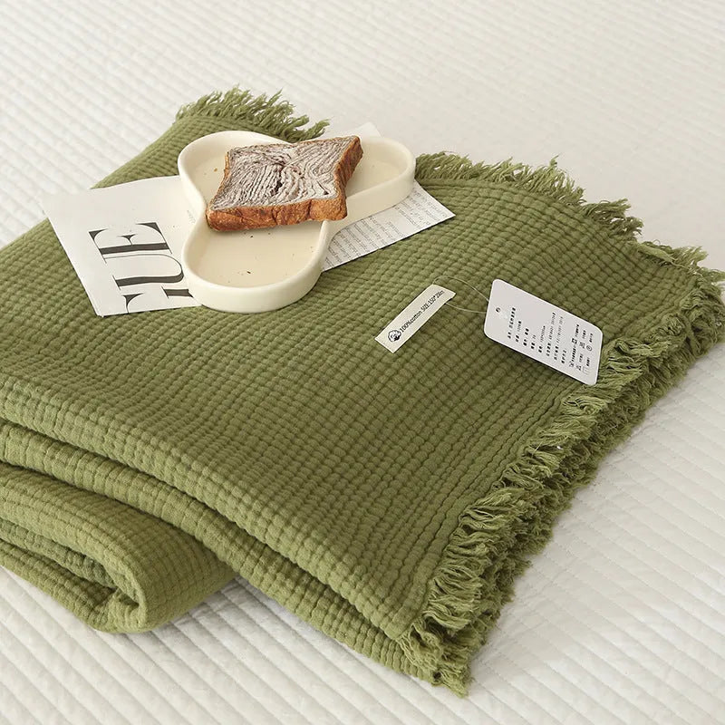 Four-layer gauze cotton blanket with tassel trim in a choice of ten colours and two sizes.