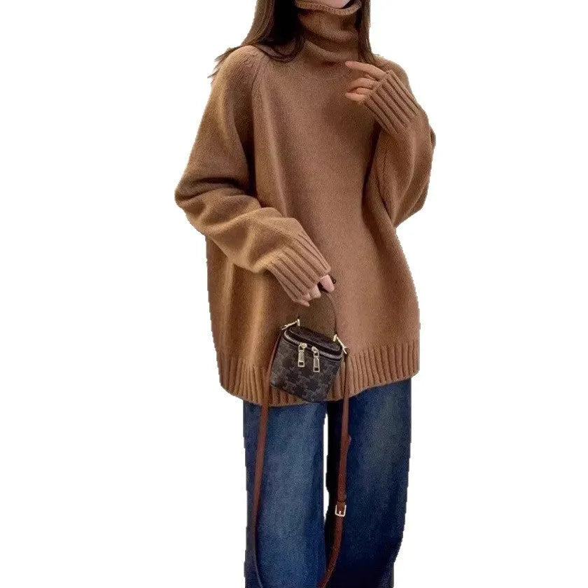 Women's loose grey turtleneck sweater with thick curling pile collar, worn in a casual setting.