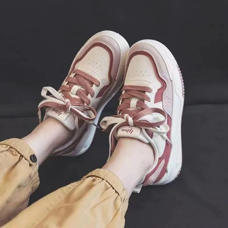 Beige and pink low-top sneakers with rubber soles and imitation leather lining