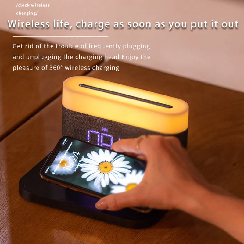 Mini black and white desk lamp with integrated wireless charging pad and clock display.