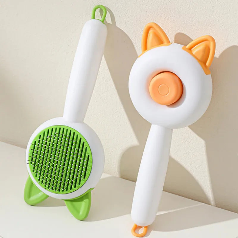 Self-cleaning cat grooming comb in greenish white and orange white colour options