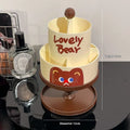 Beige rotating cosmetic brush storage barrel with 18-litre capacity on a table.