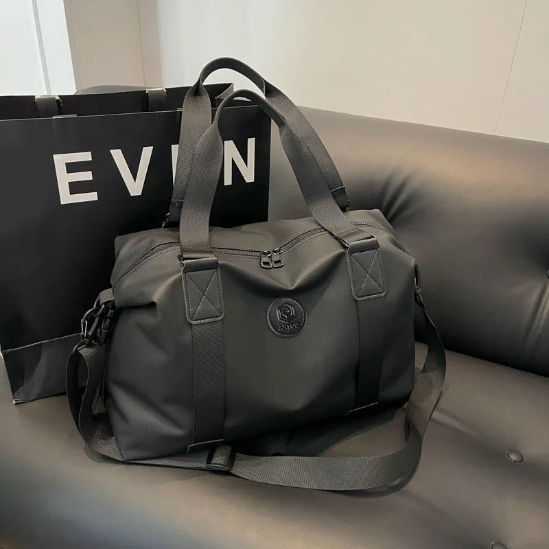 Large black waterproof Oxford cloth travel bag with dry-wet separation compartments.