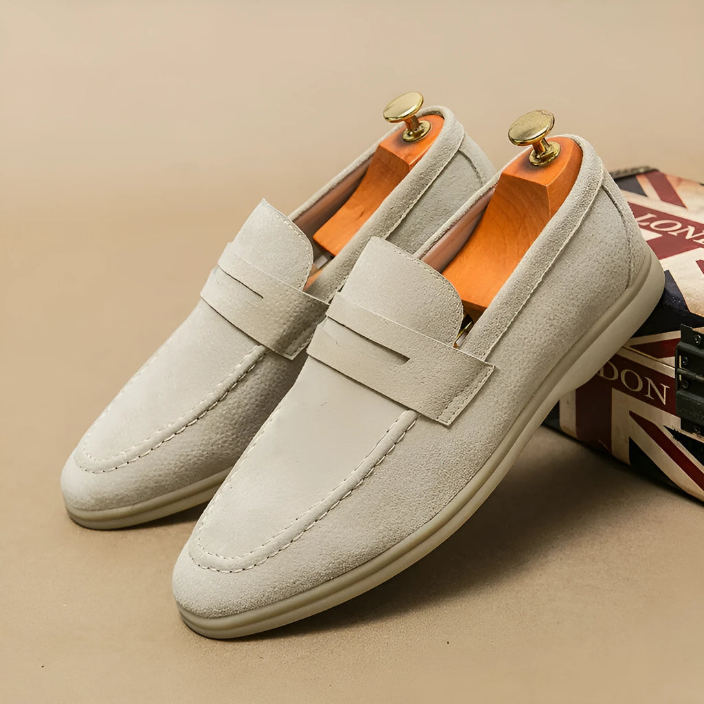 Men's beige slip-on leather casual shoes with a round toe and mid-height rubber sole.