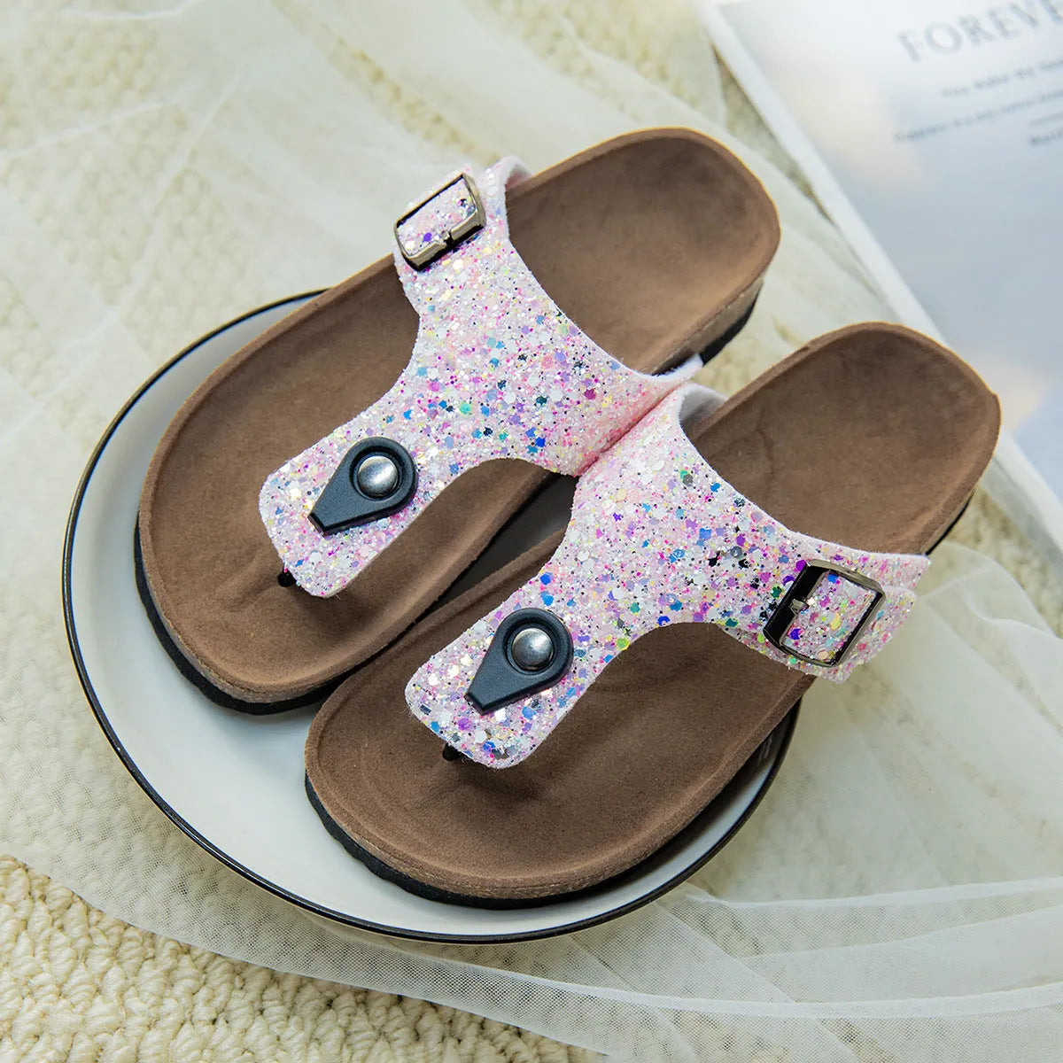 Gold cork flip-flops with a frosted artificial leather upper and a textured PVC sole.