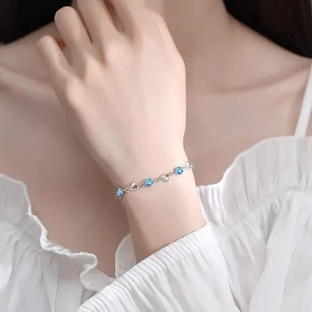 Blue heart-shaped necklace and bracelet set with mixed gem inlay on geometric pendant