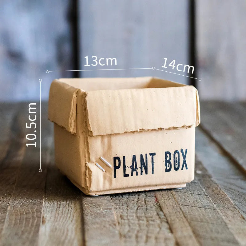 Cement flowerpot with brown paper box texture and bottom drainage holes on a floor.