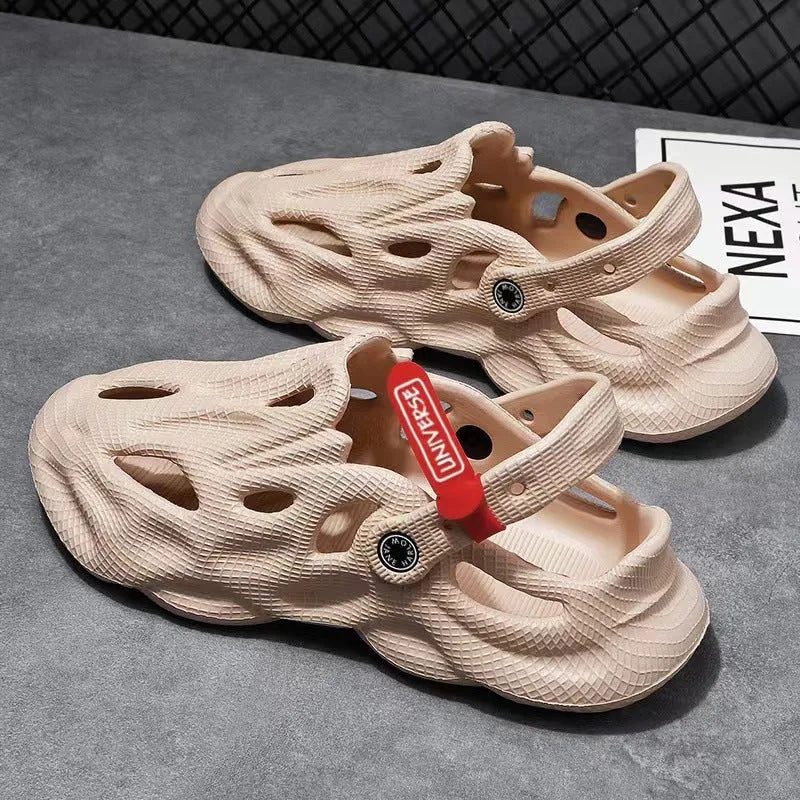 Men's grey EVA foam slippers with closed toe and thickened sole on a sandy beach.