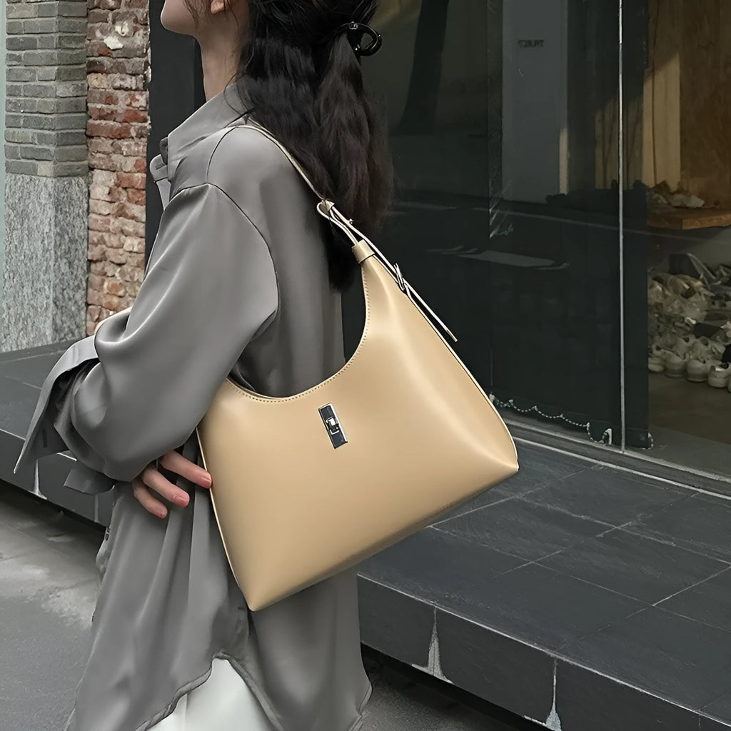 Soft genuine leather dumpling-shaped crossbody shoulder bag in a street style with lock detail