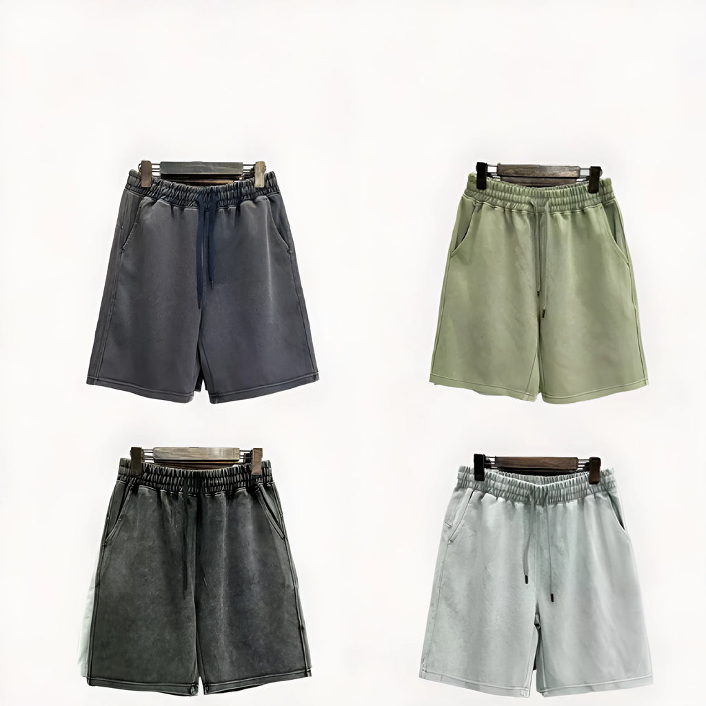 Men's loose-fit cotton shorts with a distressed finish in charcoal black, shown in a straight-leg style