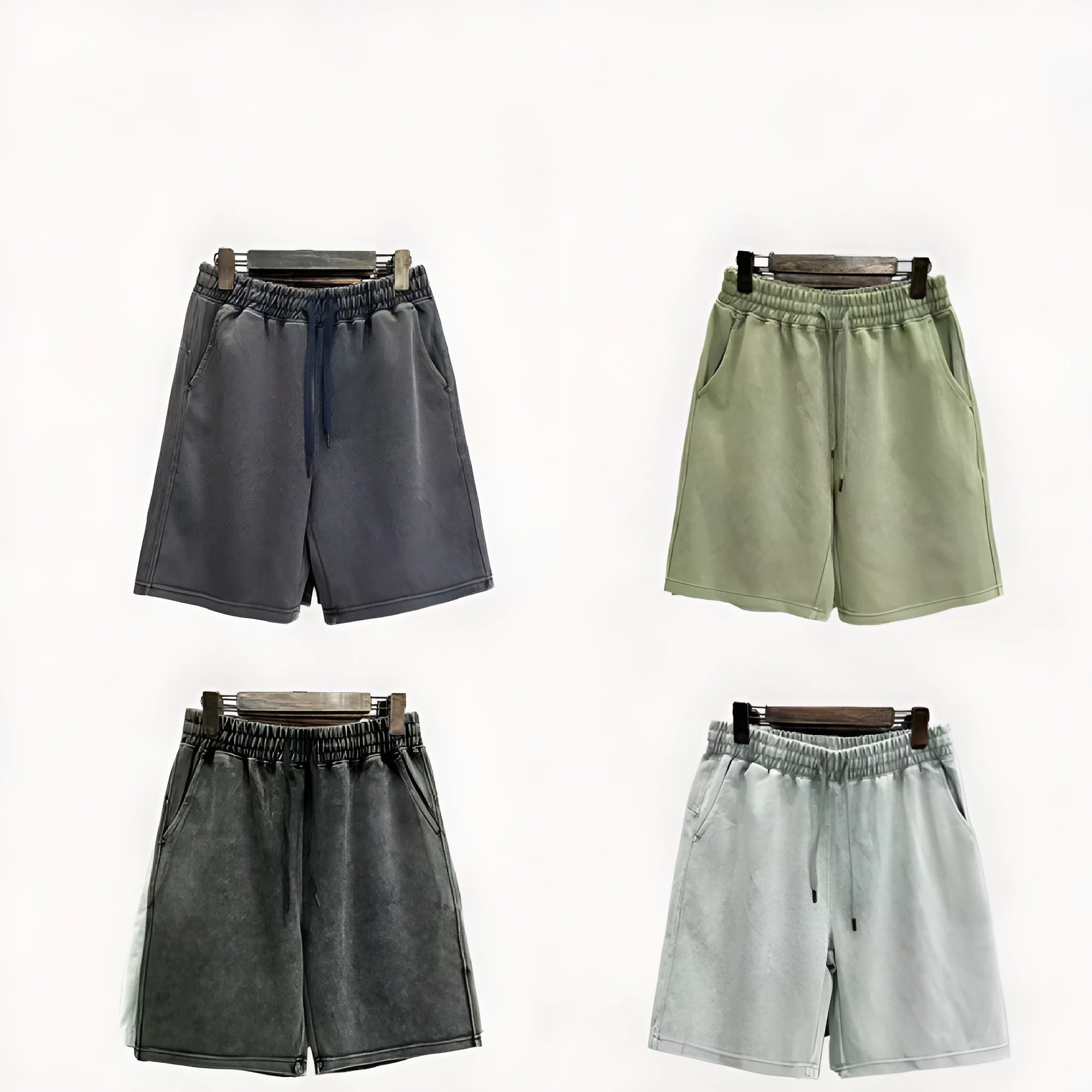 Men's loose-fit cotton shorts with a distressed finish in charcoal black, shown in a straight-leg style