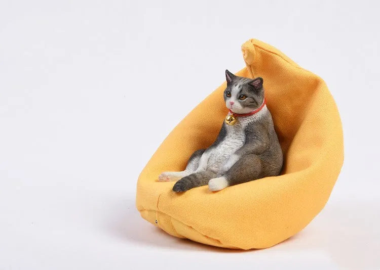 Small resin cat ornament sitting on fabric sofa for car dashboard decoration