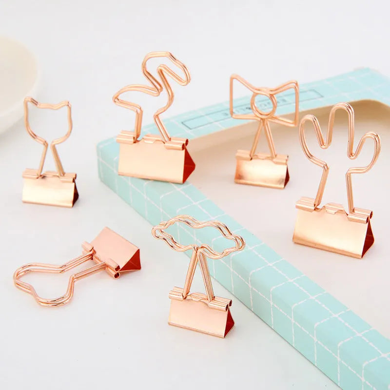 Gold metal paper clip with decorative shape options including bow, cactus, cat, flamingo, love, and clouds.