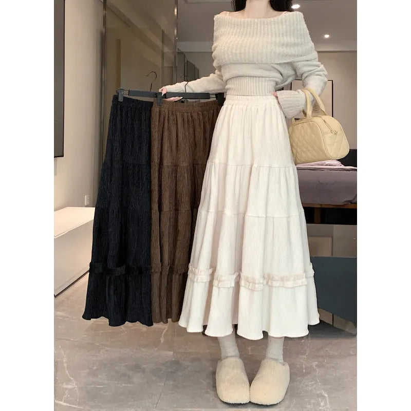 Women's beige corduroy A-line midi skirt with elastic waistband, shown on a hanger.
