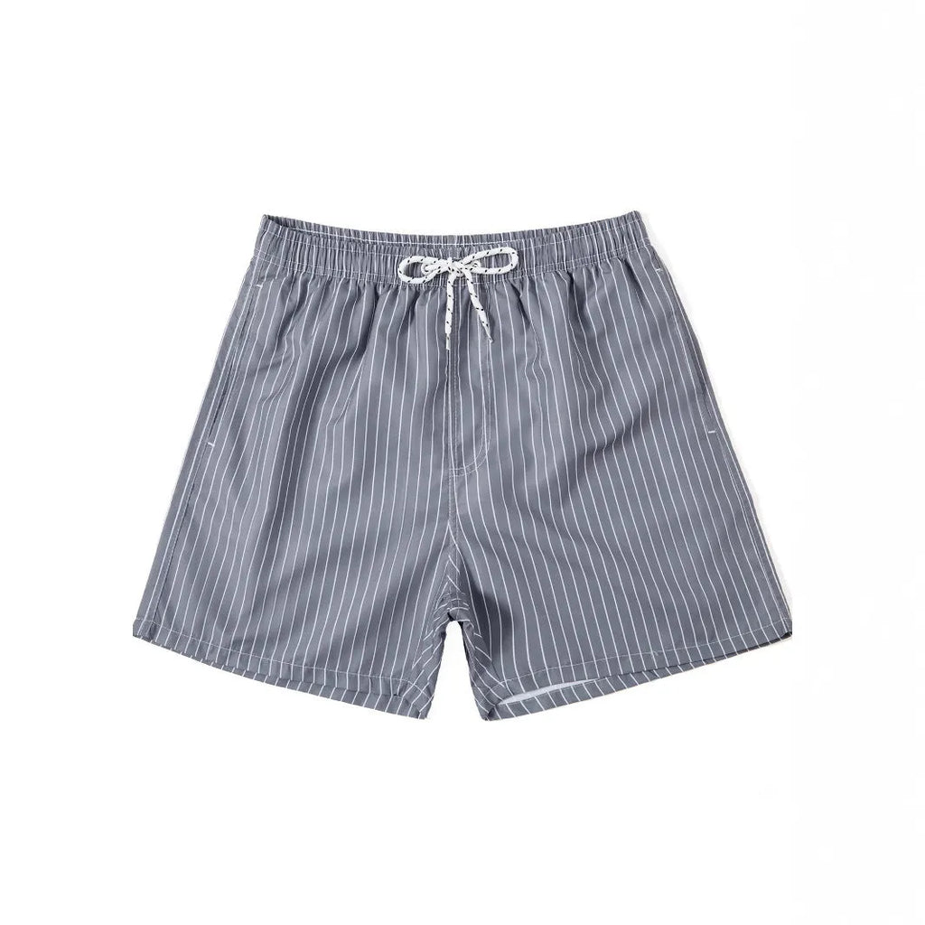 Man wearing grey striped polyester beach shorts with a straight leg opening