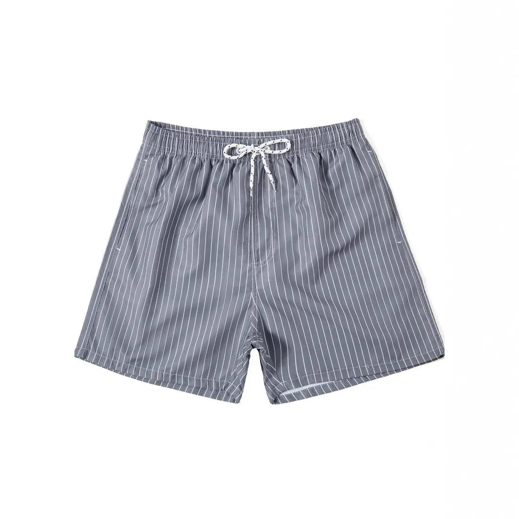 Man wearing grey striped polyester beach shorts with a straight leg opening