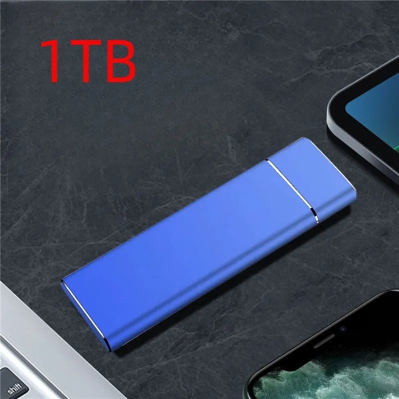 Sapphire blue metal external solid state hard disk with USB cable on a white surface
