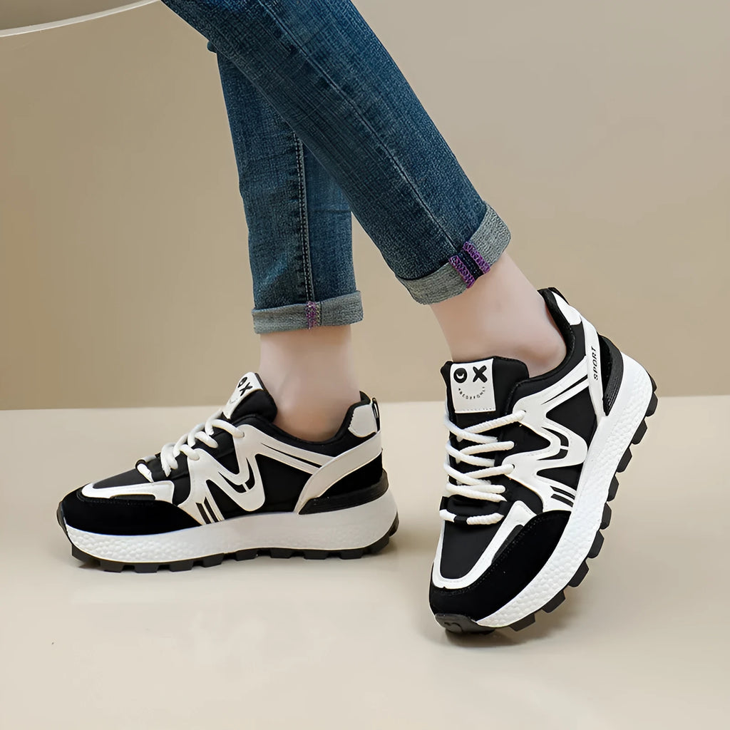 Women's black platform casual shoes with flat heel, round toe, and lace-up front on a white background.