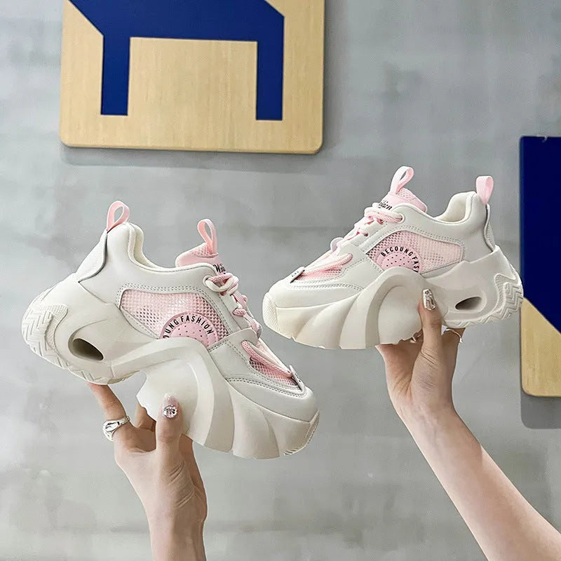 Women's beige platform sneakers with crossover ankle straps and a thick rubber sole.