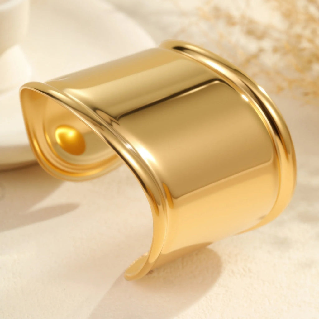 Women's fashion bracelet with exaggerated width, geometric wave patterns, and gold plating
