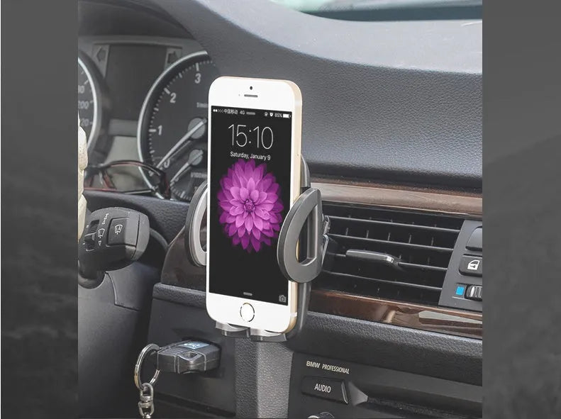 Black plastic mobile phone holder mounted on a car air conditioning vent