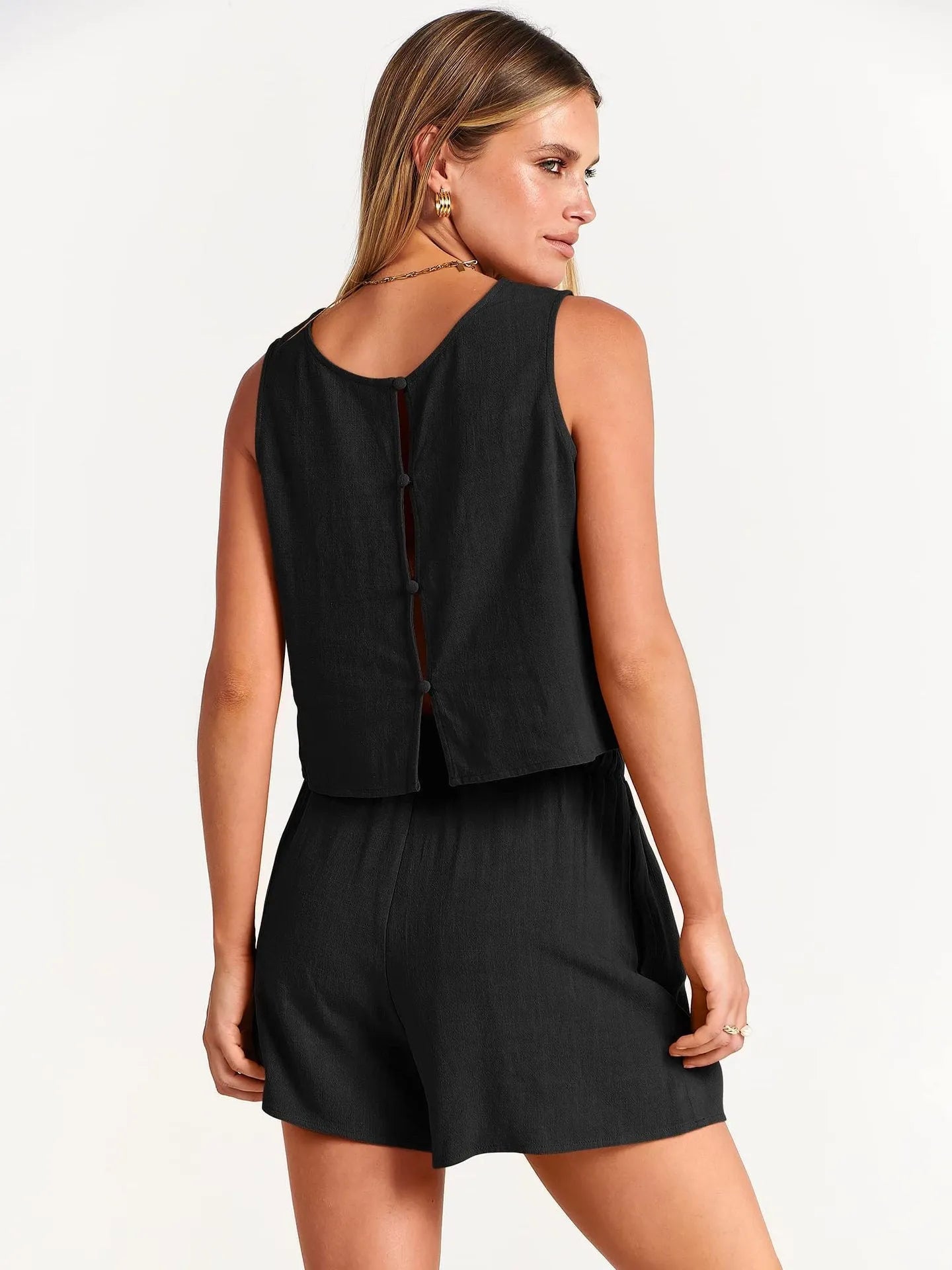 Women's apricot coloured sleeveless top and matching drawstring shorts summer two-piece set laid flat.