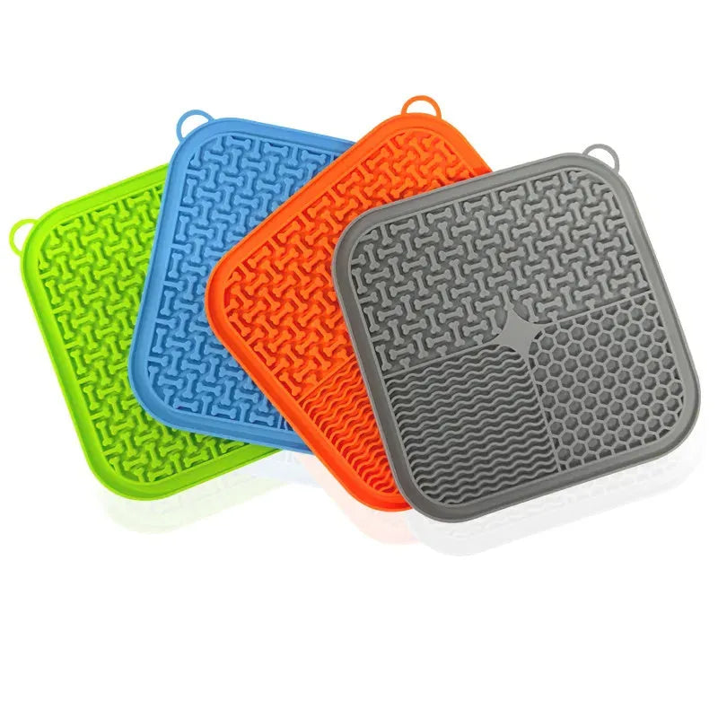 Orange and grey silicone dog licking mat with textured surface and suction cups on back
