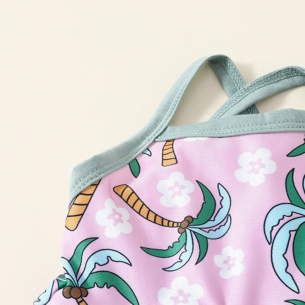 Girls' white two-piece swimsuit set with a shirt and matching shorts on a hanger