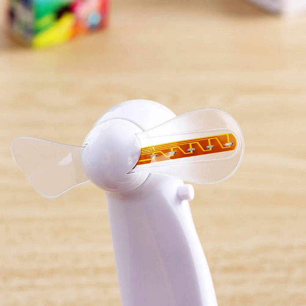 White handheld mini fan with LED love pattern display showing blue and red colours