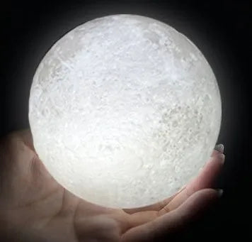 3D printed white moon lamp on wooden stand showing detailed lunar surface texture.