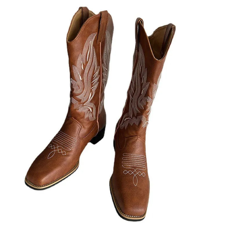Brown women's mid-calf embroidered Martin boots with a leather lining and low rubber heel.