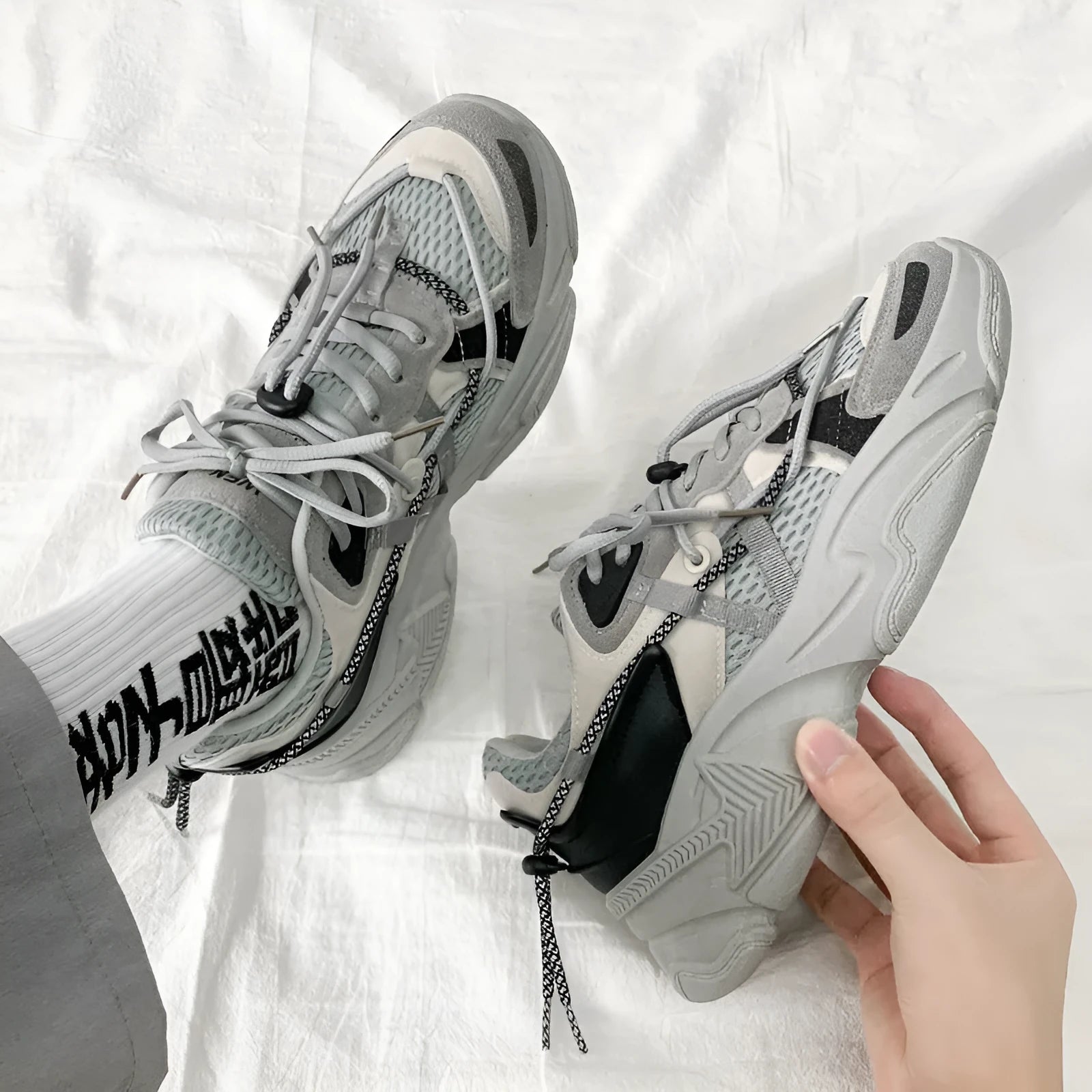 Men's white Korean style platform dad shoes with lace-up front on a neutral background.