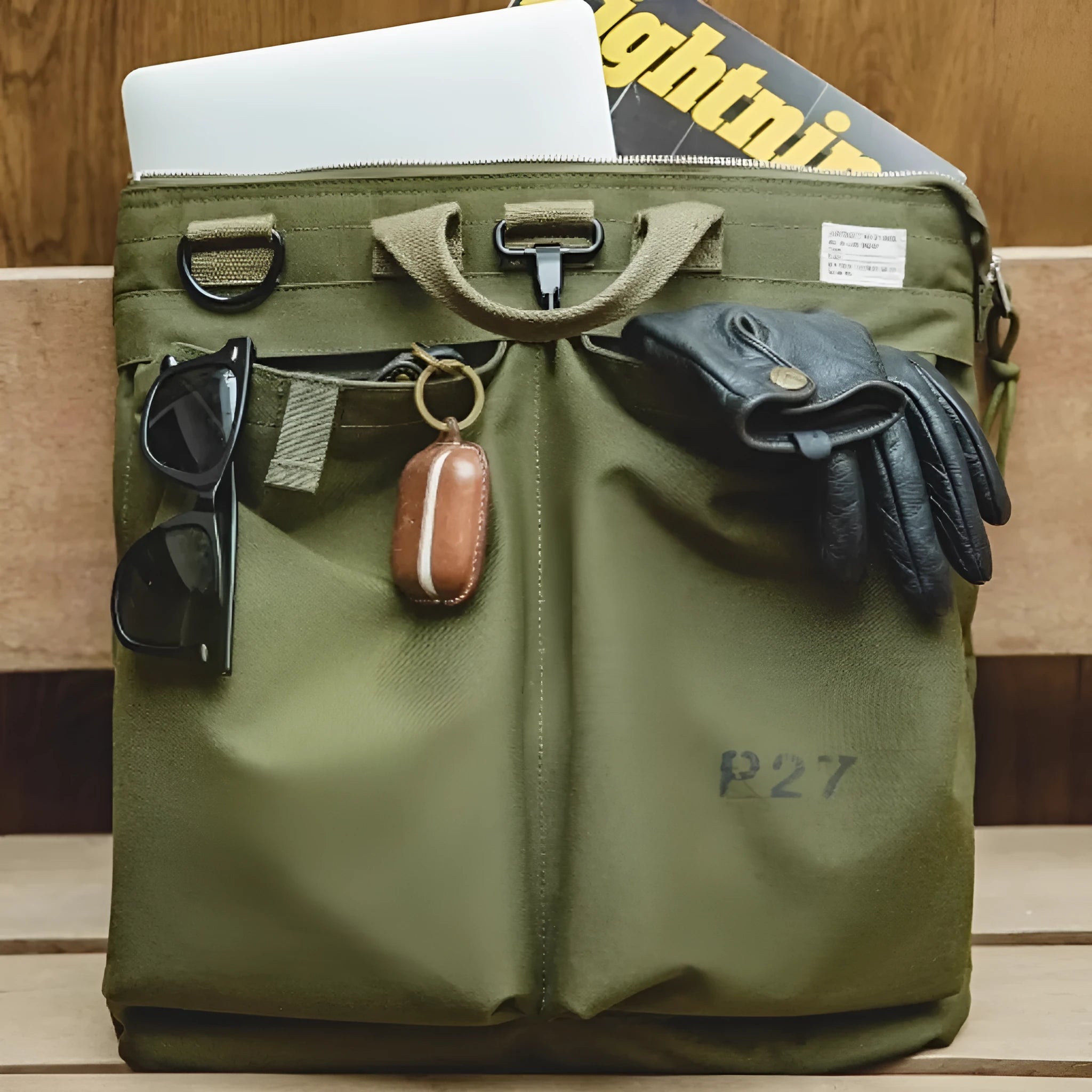 Retro canvas crossbody messenger bag in military green showing laptop compartment and phone storage