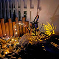 Solar garden lamp with tapered butterfly pattern design in iron construction