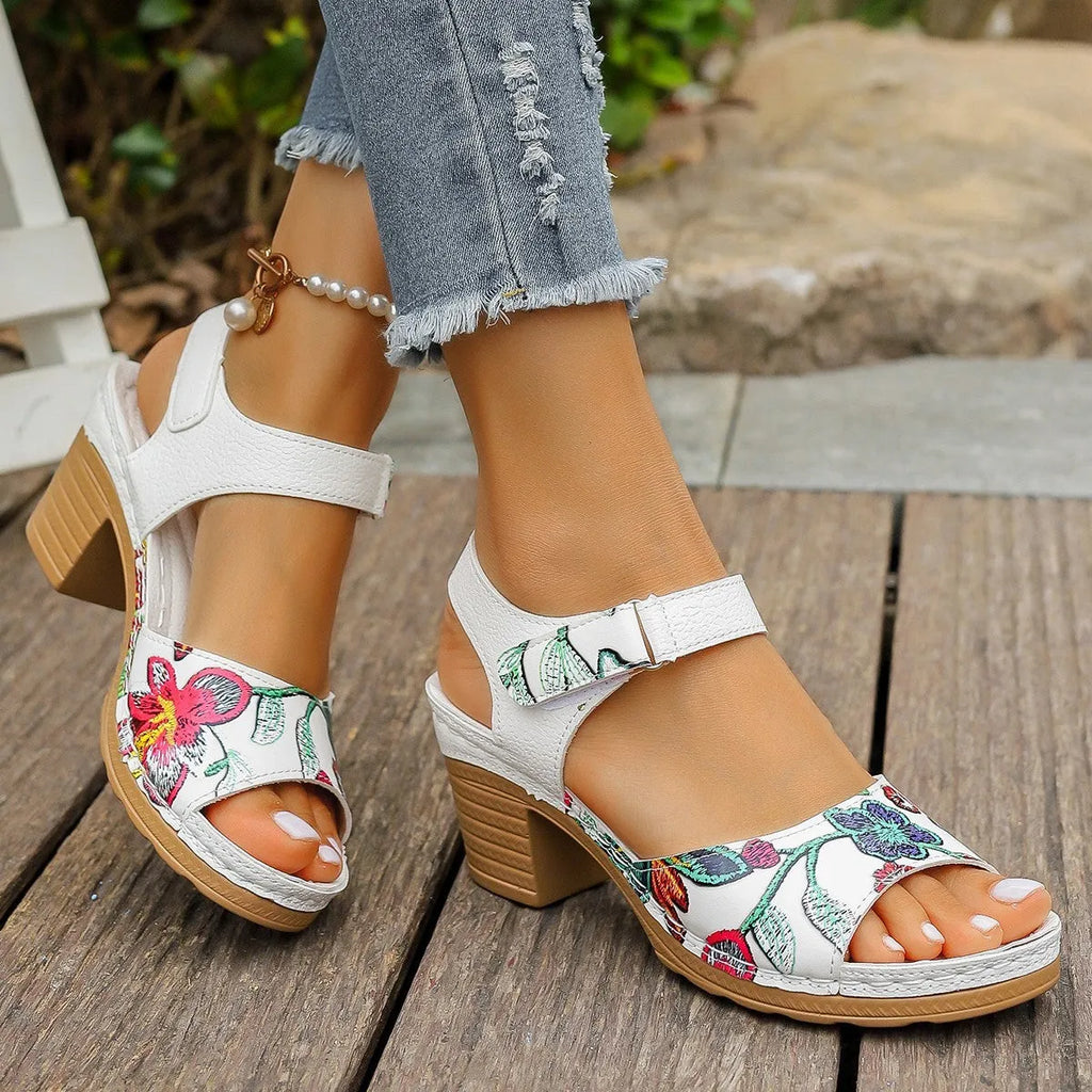 White women's high heel sandals with a Velcro strap closure on a rubber sole.