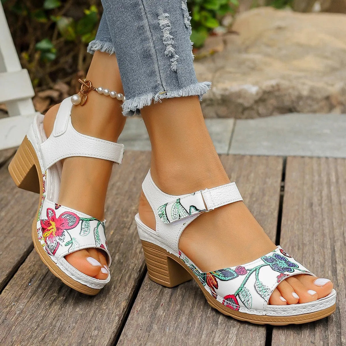 White women's high heel sandals with a Velcro strap closure on a rubber sole.