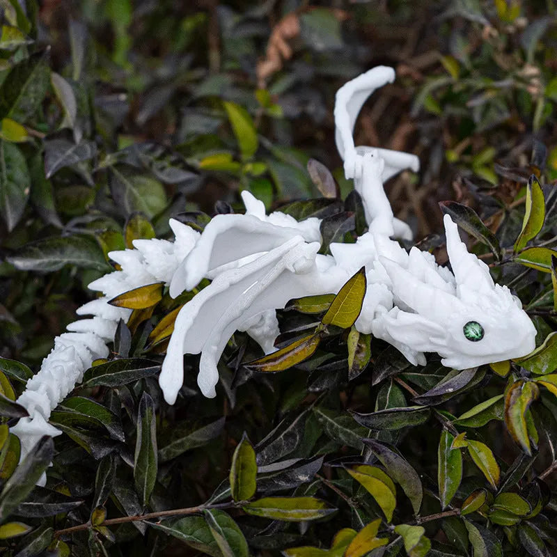 3D printed red and gold flying dragon wings decoration toy on a white background.
