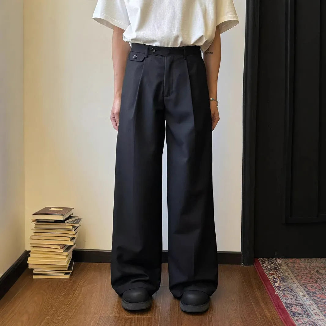 Men's brown straight-leg casual trousers with a loose wide-leg cut on a neutral background.